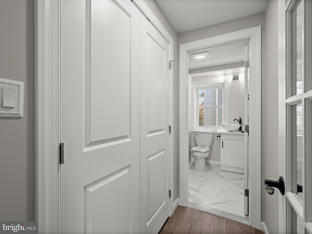 bathroom featuring hardwood / wood-style flooring, sink, and toilet