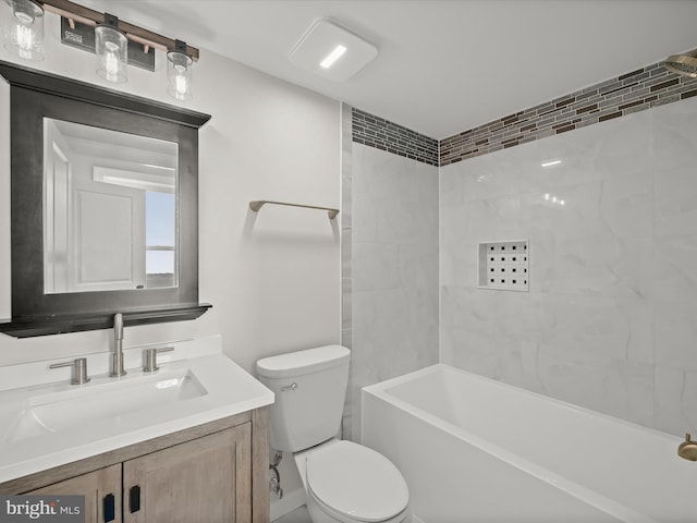 full bathroom featuring tiled shower / bath combo, vanity, and toilet