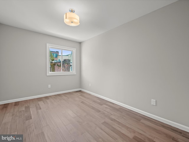 empty room with light hardwood / wood-style flooring