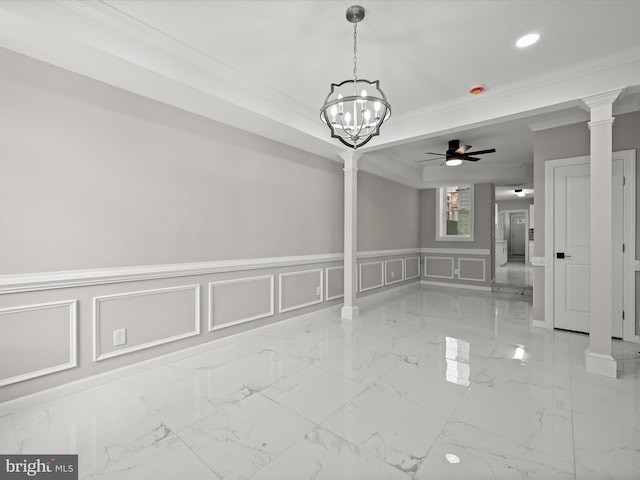 empty room featuring ceiling fan with notable chandelier, crown molding, and decorative columns