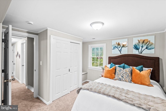 carpeted bedroom featuring ornamental molding and a closet