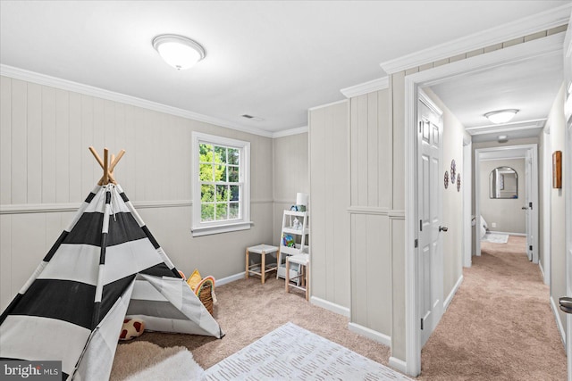 playroom with ornamental molding and light carpet