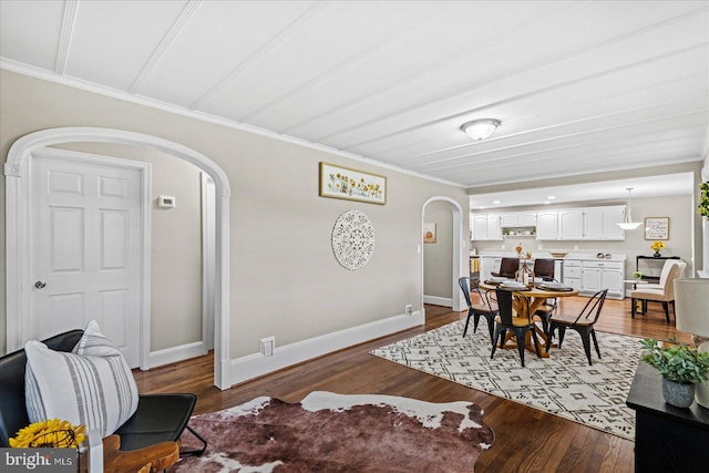 dining space with wood-type flooring and crown molding