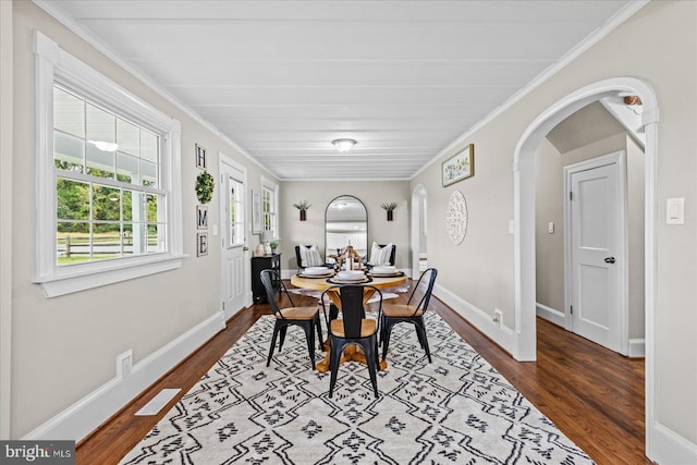 dining space featuring hardwood / wood-style floors and crown molding