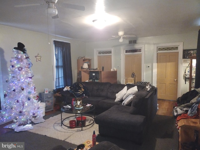 living room featuring ceiling fan and hardwood / wood-style floors