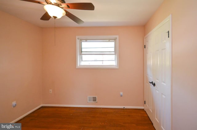 spare room with ceiling fan and dark hardwood / wood-style floors