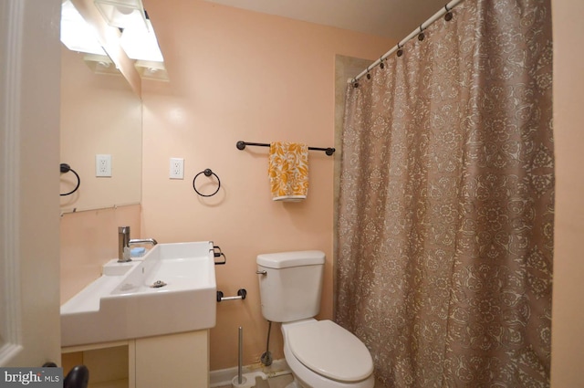 bathroom featuring toilet, a skylight, and a shower with curtain