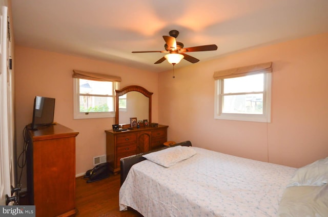 bedroom featuring ceiling fan and dark wood-type flooring