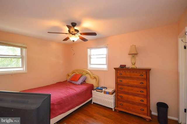 bedroom with dark hardwood / wood-style floors and ceiling fan