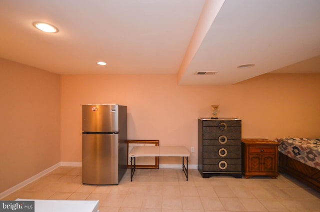 bedroom featuring stainless steel refrigerator