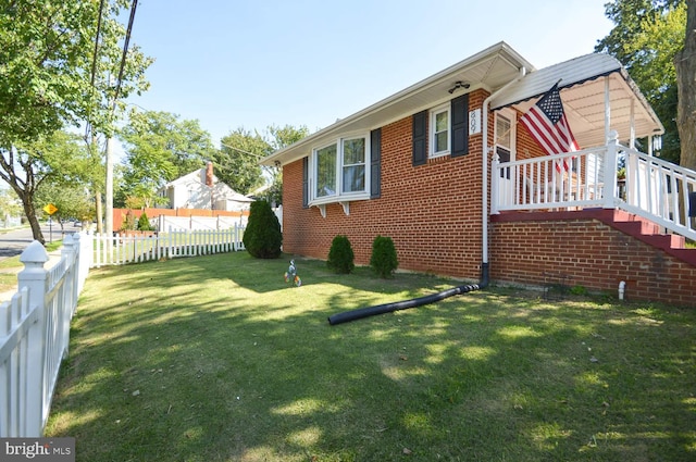 view of side of property with a lawn