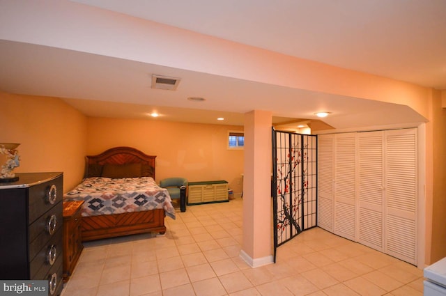 bedroom with a closet and light tile patterned floors