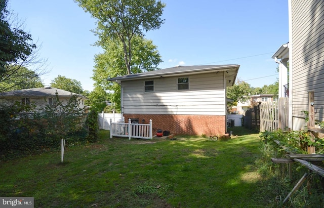 rear view of property featuring a lawn