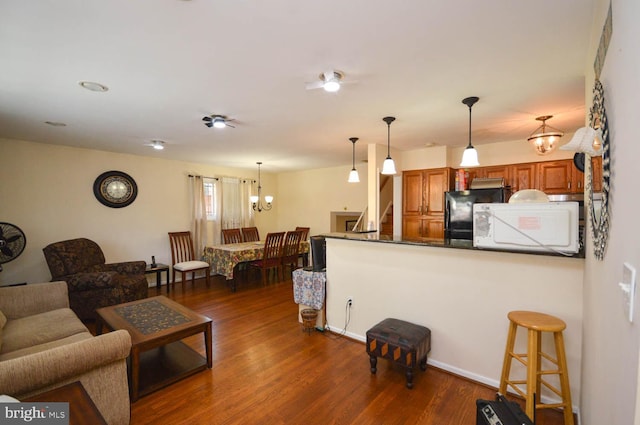 living room with a chandelier and dark hardwood / wood-style floors