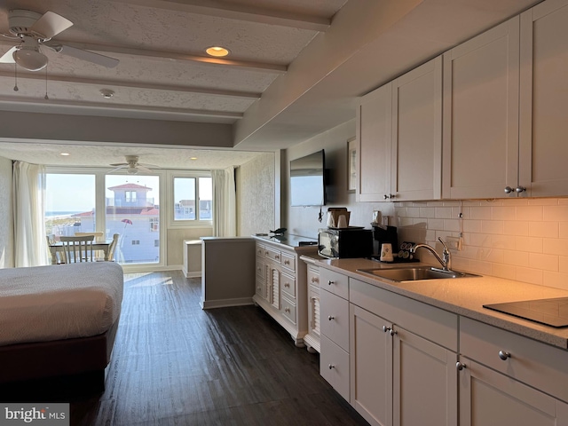 kitchen featuring white cabinetry, dark hardwood / wood-style flooring, ceiling fan, black electric stovetop, and sink