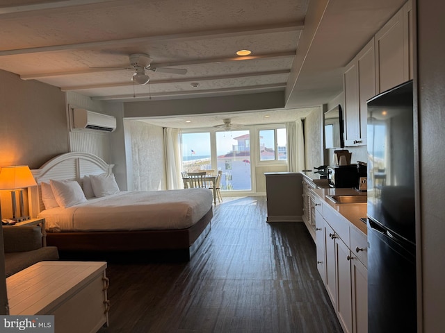 bedroom with a wall unit AC, dark wood-type flooring, beam ceiling, fridge, and ceiling fan