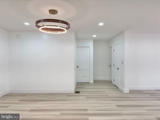 interior space with an inviting chandelier and light hardwood / wood-style flooring