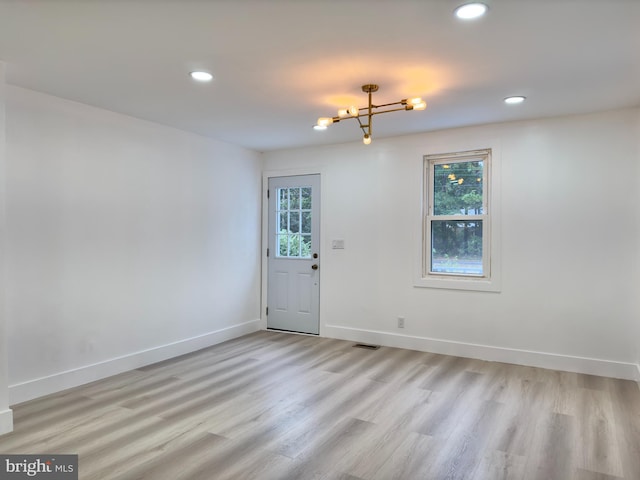 empty room with light wood-type flooring and a wealth of natural light