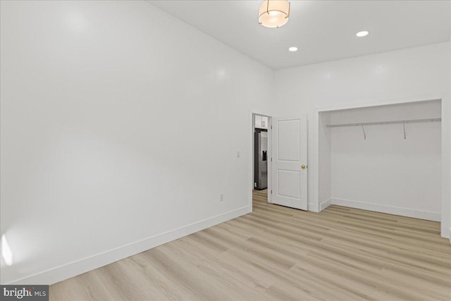 interior space with a high ceiling and light wood-type flooring