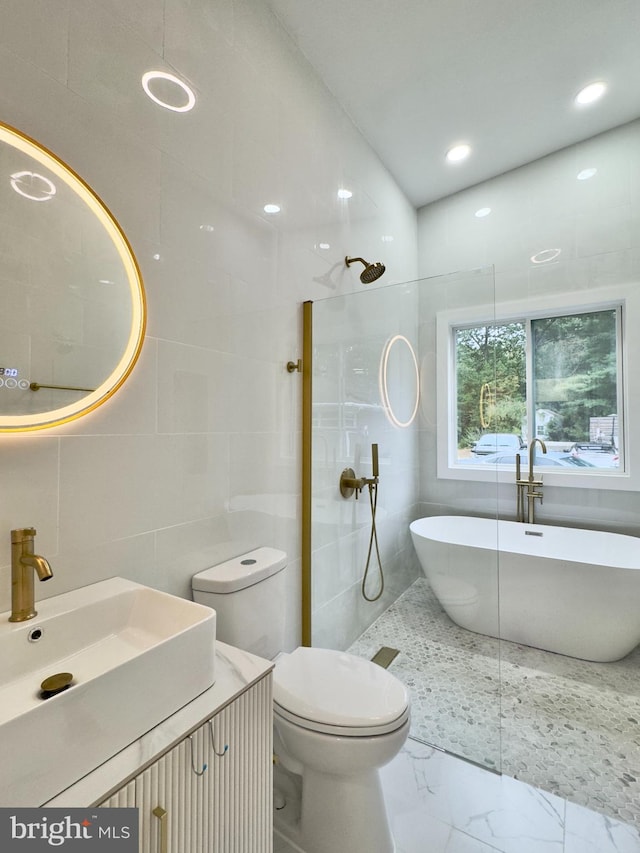 full bathroom with vanity, toilet, independent shower and bath, and tile walls