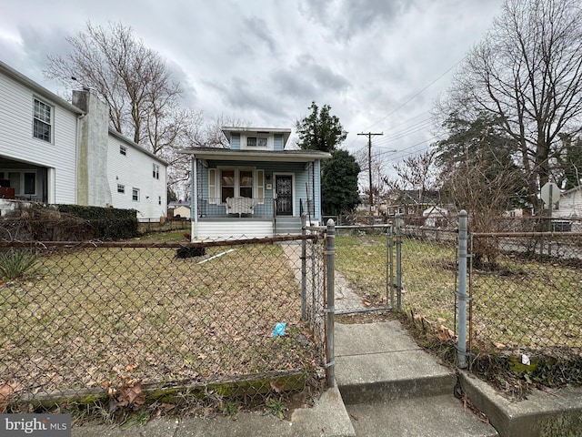 bungalow-style house with a front yard and a porch