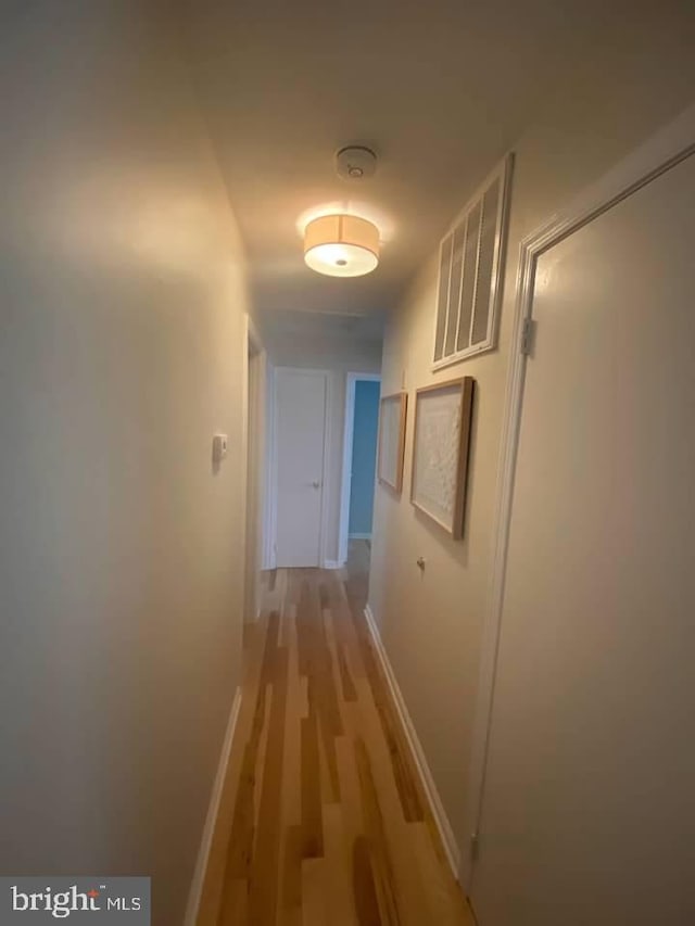 hall with light hardwood / wood-style floors