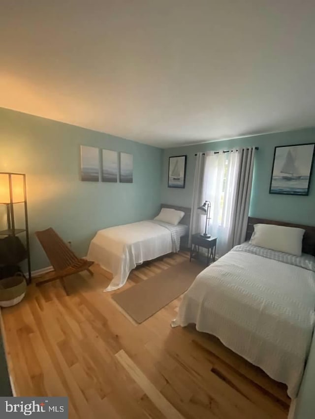 bedroom with hardwood / wood-style floors