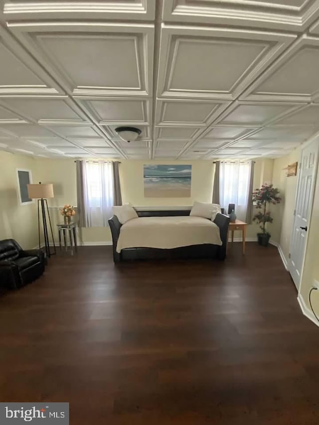 unfurnished bedroom with coffered ceiling and dark hardwood / wood-style floors