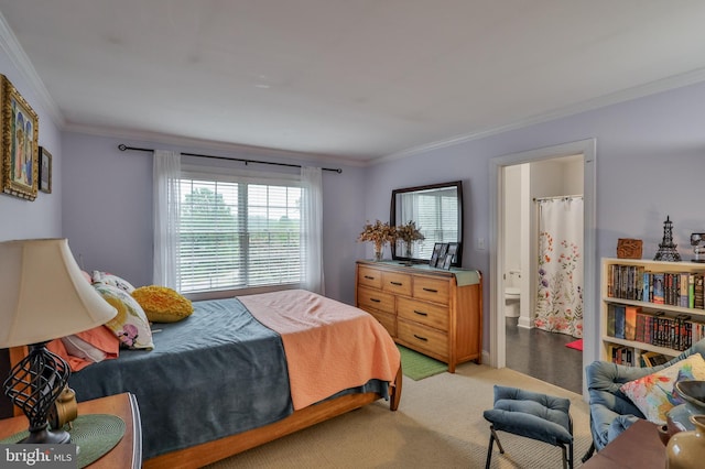 carpeted bedroom with ensuite bath and crown molding