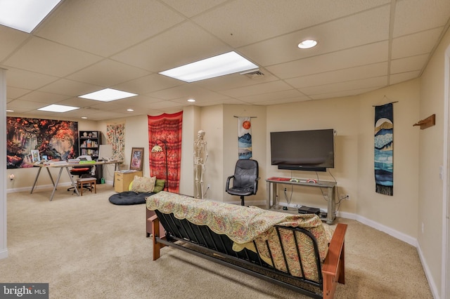 living room featuring a drop ceiling and light colored carpet