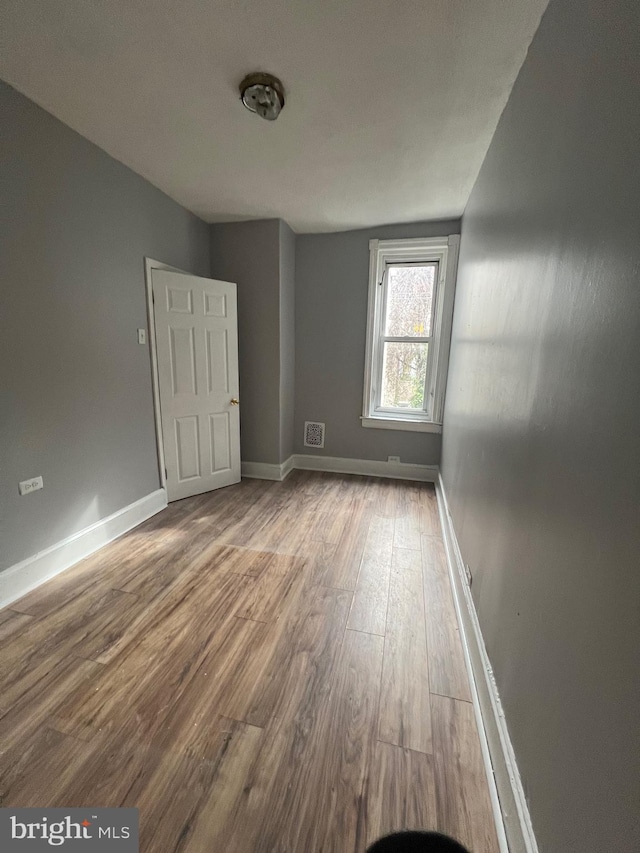 spare room featuring light hardwood / wood-style floors