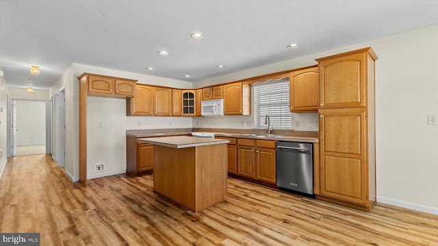 kitchen featuring a center island, dishwasher, light hardwood / wood-style flooring, and sink