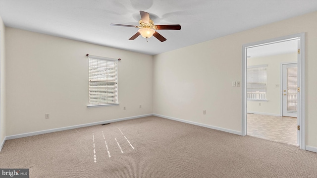 unfurnished room featuring ceiling fan and light colored carpet