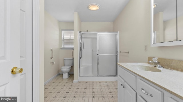 bathroom with vanity, toilet, and an enclosed shower