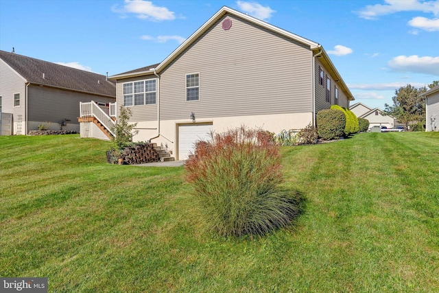 view of home's exterior featuring a garage and a yard