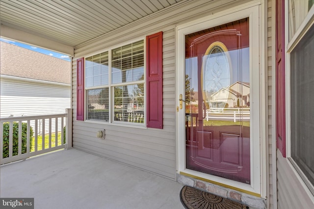 view of exterior entry with a porch