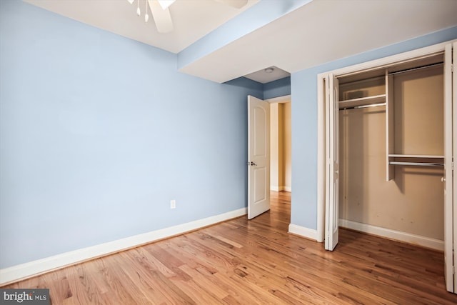 unfurnished bedroom featuring ceiling fan, a closet, and light hardwood / wood-style floors