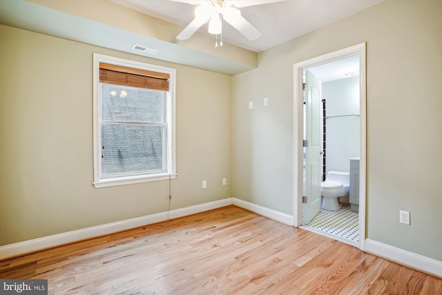 unfurnished bedroom featuring light hardwood / wood-style flooring, ceiling fan, and ensuite bathroom