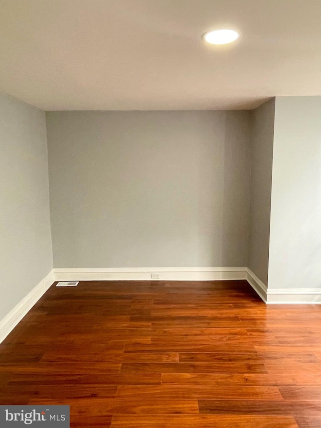 unfurnished room with wood-type flooring