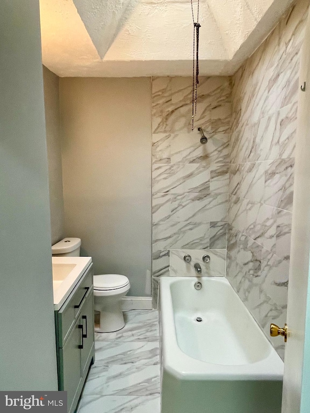 bathroom with a bath, vanity, and toilet