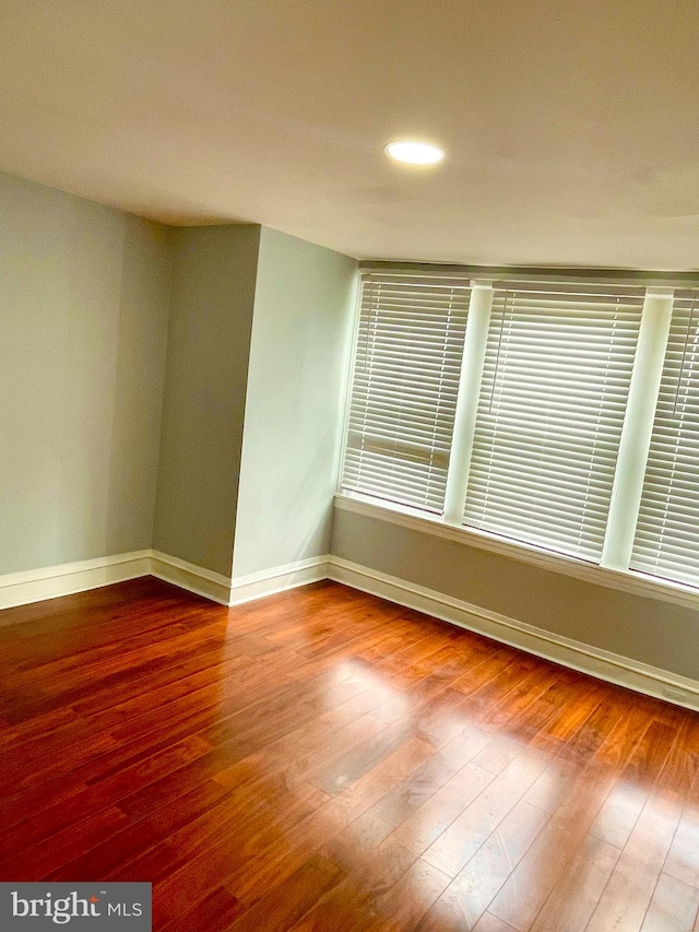 spare room with hardwood / wood-style flooring