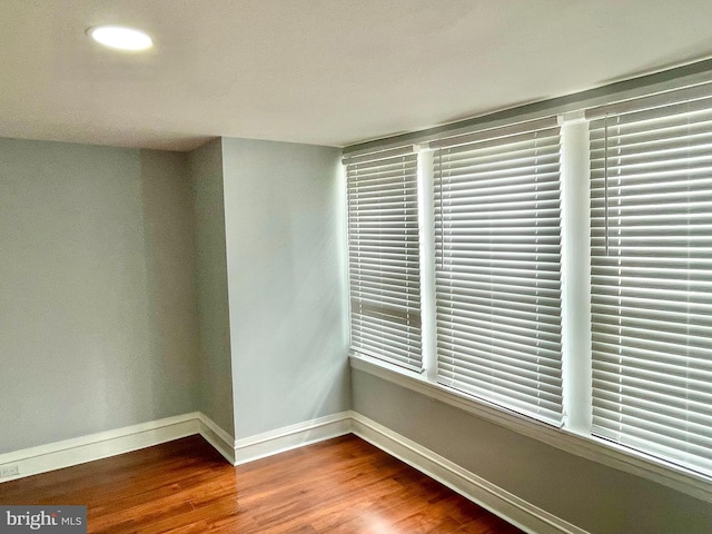 spare room with hardwood / wood-style flooring