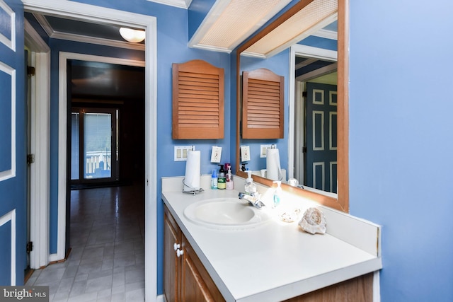 bathroom with vanity and ornamental molding