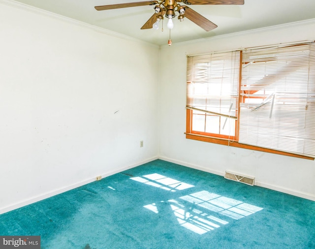 unfurnished room featuring ornamental molding, carpet, and ceiling fan