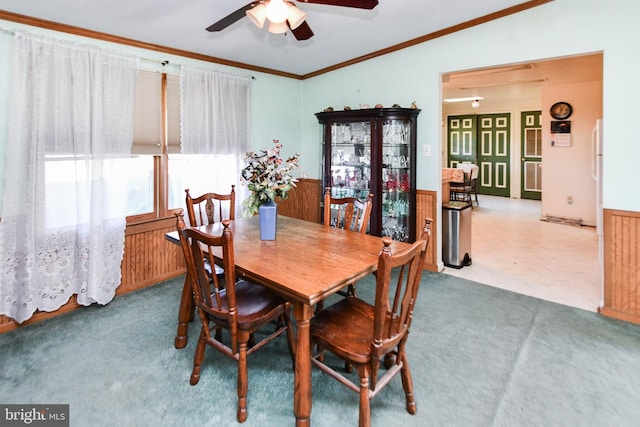 dining area with crown molding, lofted ceiling, carpet flooring, and ceiling fan