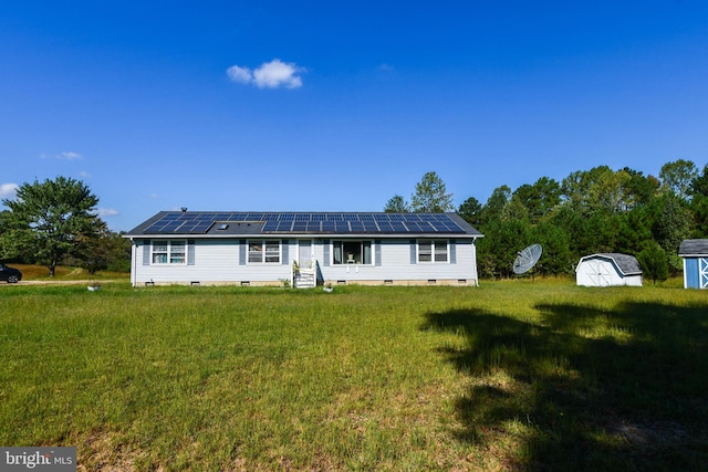 single story home featuring a front lawn and a shed