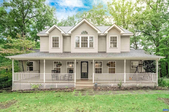 farmhouse-style home featuring covered porch and a front lawn