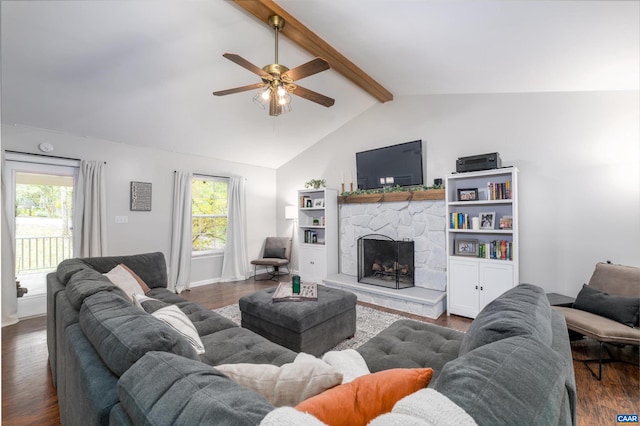 living room with vaulted ceiling with beams, a stone fireplace, dark hardwood / wood-style flooring, and ceiling fan