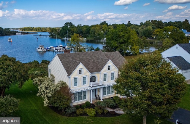 birds eye view of property with a water view