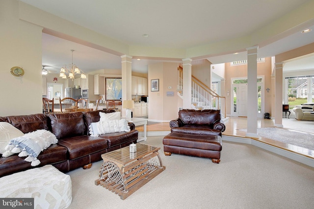 carpeted living room with an inviting chandelier